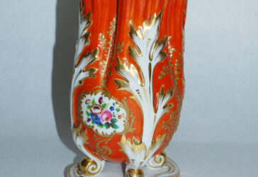 Vase en porcelaine émaillée à fond orange, rehaussée de dorure à décor de fleurs. De style rocaille. Dans le goût de Sèvres.